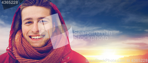 Image of close up of happy man in winter jacket with hood