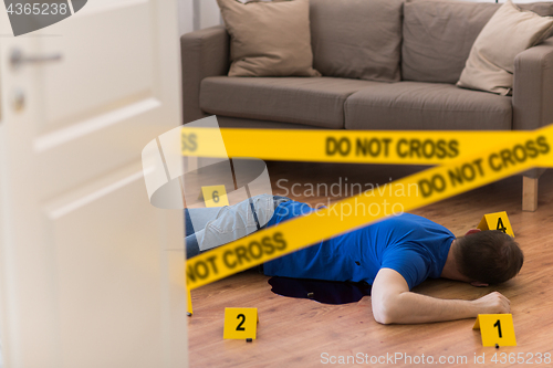 Image of dead man body in blood on floor at crime scene