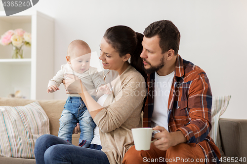 Image of happy family with baby at home