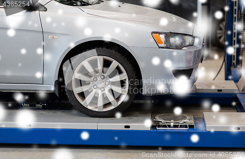 Image of car on lift at repair station