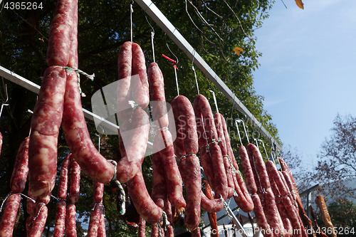 Image of The suspended pieces of the meat drying outside