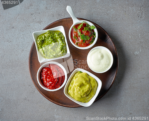 Image of various sauces on grey table