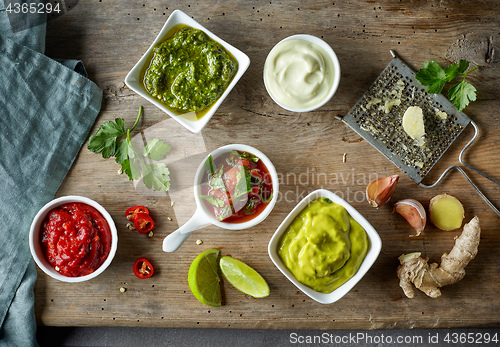 Image of various sauces on wooden table