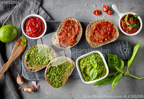 Image of Bread slices with basil pesto and garlic tomato sauce