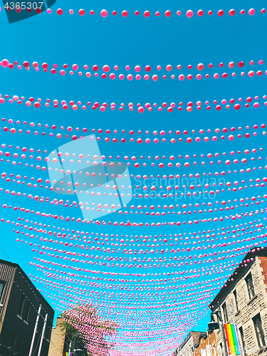 Image of Joyful street in gay neighborhood decorated with pink balloons