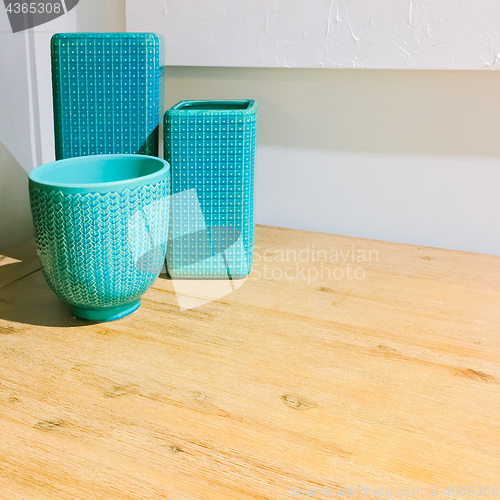 Image of Turquoise ceramic vases decorating a table