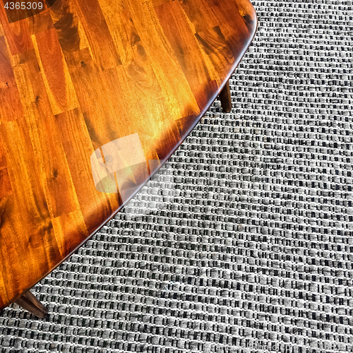 Image of Retro style wooden table on gray rug