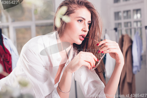 Image of Fashion designers working in studio sitting on the desk