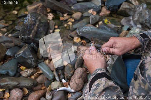 Image of Fisherman cleaning fish