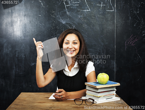 Image of portrait of happy cute real teen student in classroom at blackboard close up, lifestyle education people concept close up