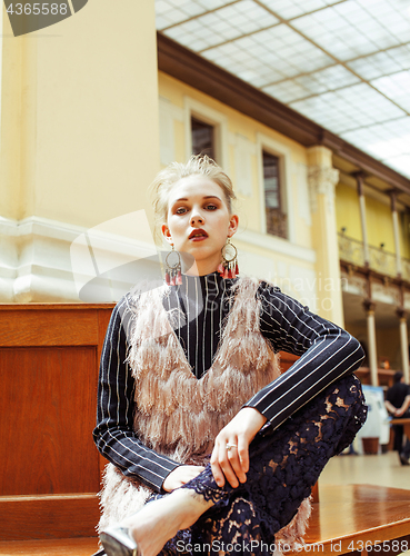 Image of young attractive fashion lady on railway station waiting, vintag