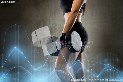 Image of woman with dumbbell in gym