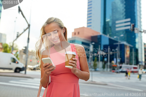 Image of woman with coffee and smartphone in city