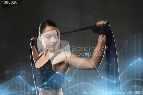 Image of woman with expander exercising in gym