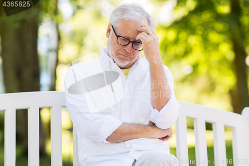 Image of thoughtful senior man at summer park