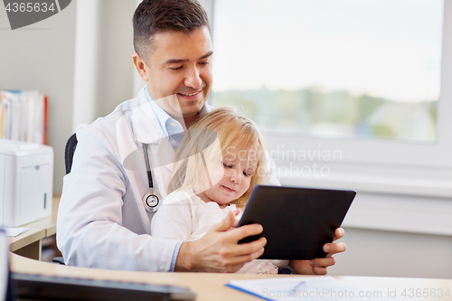 Image of doctor and little girl with tablet pc at clinic