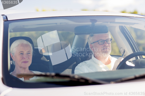 Image of happy senior couple driving in car