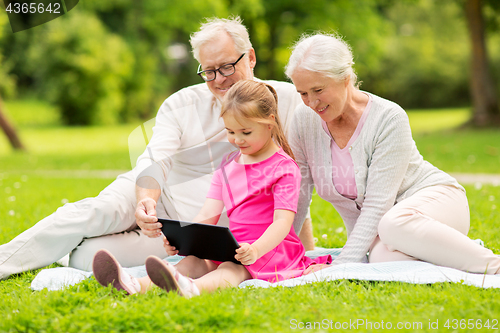 Image of grandparents and granddaughter with tablet pc