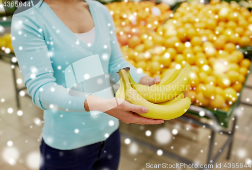 Image of customer with bananas at grocery store