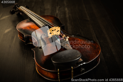 Image of Old violin in vintage style on wood background