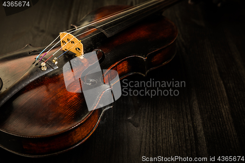 Image of Old violin in vintage style on wood background