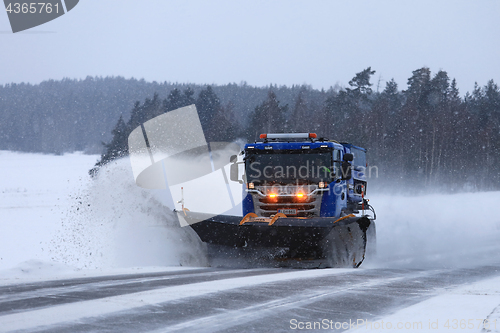 Image of Snowplow Clears Highway in Snowfall