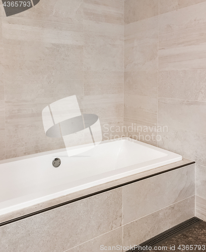 Image of New bathroom with ceramic tile walls in beige tones