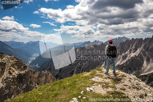 Image of Hiker woman standing up achieving the top Dolomites Alps.