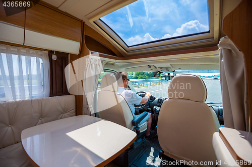 Image of Man driving on a road in the Camper Van RV