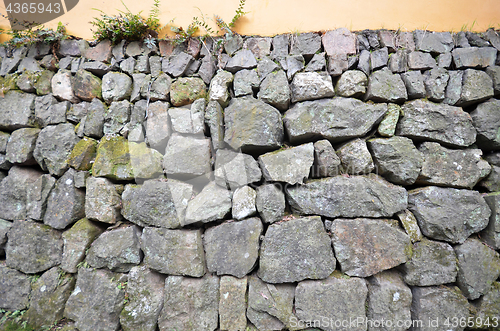 Image of Wall of rough and stacked stones 