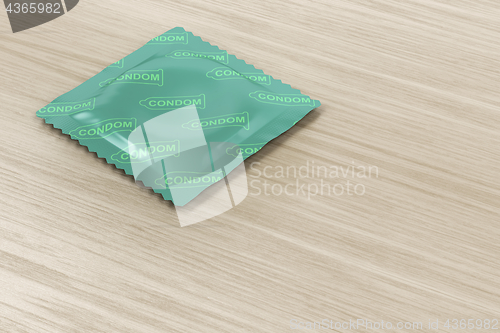 Image of Condom on wood background