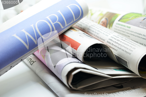 Image of Rolled newspaper with the world news