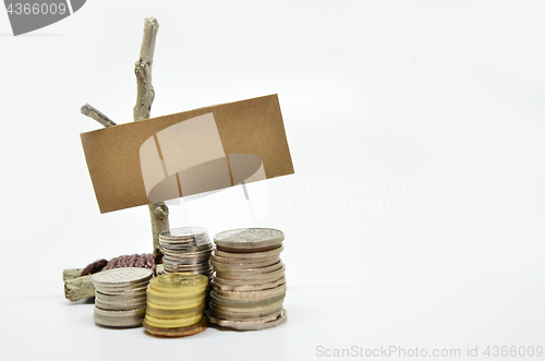 Image of Paper sign board with stack of coins