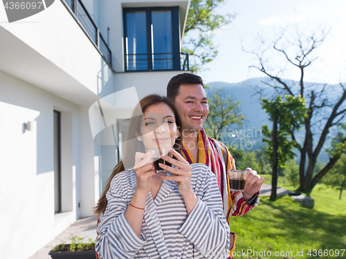 Image of Young beautiful couple in bathrobes
