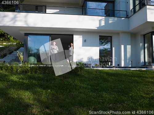 Image of couple enjoying on the door of their luxury home villa