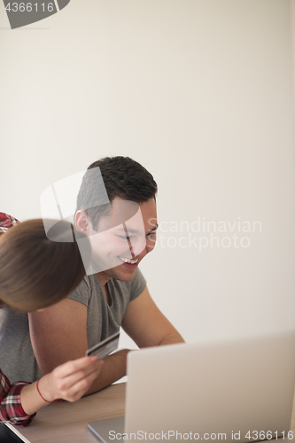 Image of happy young couple buying online