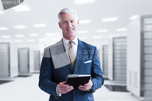 Image of Senior businessman in server room