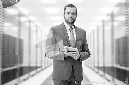 Image of Young businessman in server room