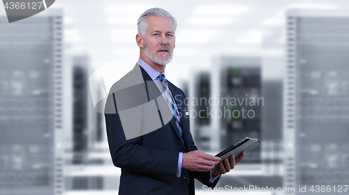 Image of Senior businessman in server room