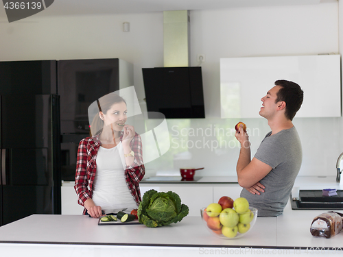 Image of Young handsome couple in the kitchen