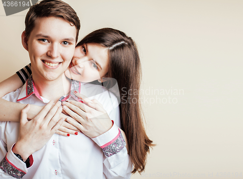 Image of couple of happy smiling teenagers students, warm colors having a kiss, lifestyle people concept, boy and girl together