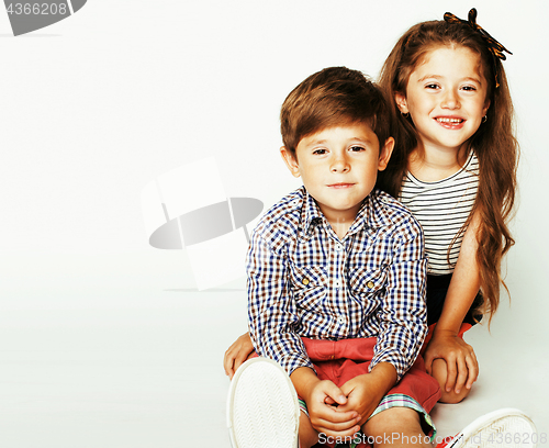 Image of little cute boy and girl hugging playing on white background, ha