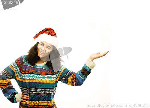 Image of young pretty african american girl in red christmas hat isolated