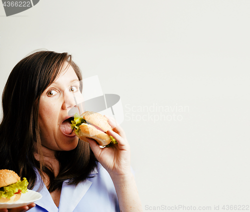 Image of fat white woman having choice between hamburger and salad