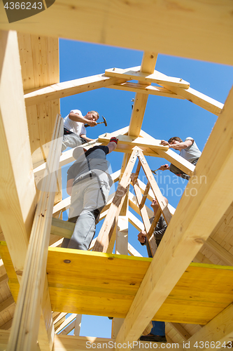 Image of Builders at work with wooden roof construction.