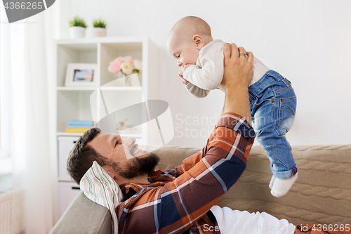 Image of happy father with little baby boy at home