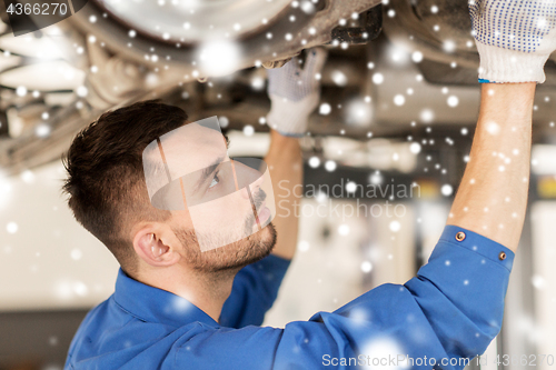 Image of mechanic man or smith repairing car at workshop