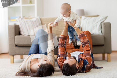 Image of happy family playing with baby at home