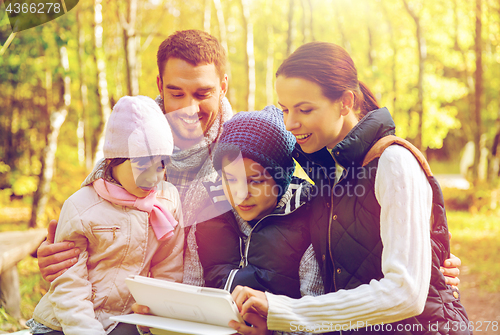 Image of happy family with tablet pc at camp