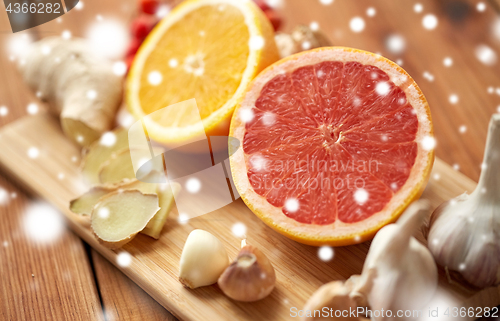 Image of citrus, ginger, garlic and rowanberry on wood